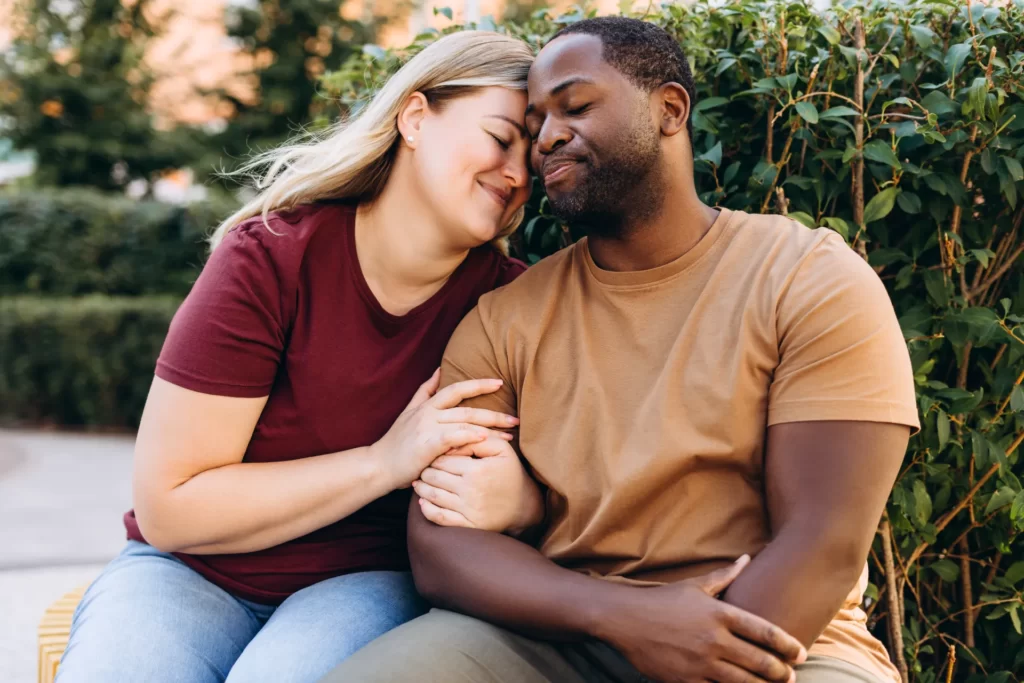 loving couple embracing outdoors in a park setting utc